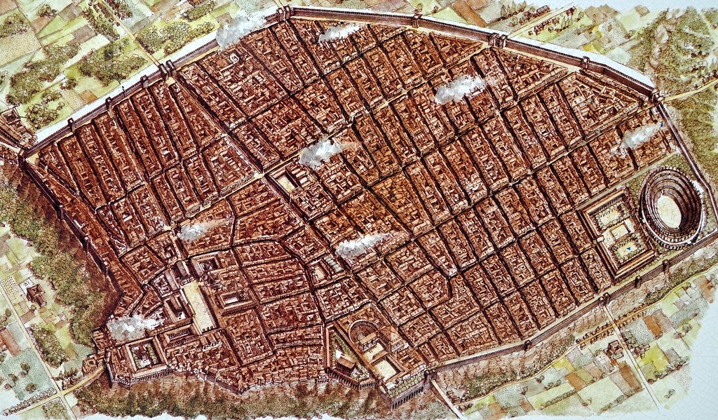 A colored bird's-eye plan of the excavated city of Pompeii, showing the city walls, street grid, forum and amphitheater.
