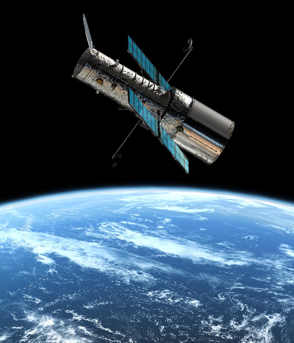 The Hubble Space Telescope in orbit above a cloud-covered Earth, solar panels extended and the open end of its tube facing away from the planet.