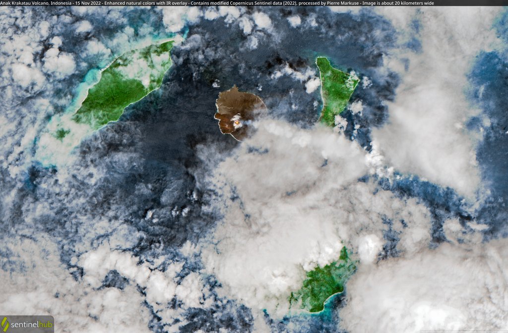 An enhanced-color satellite view of a bare volcanic island ringed by green forested islands under scattered cloud.
