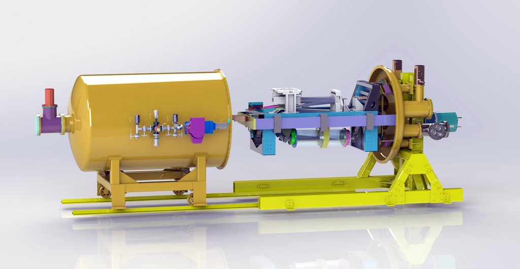 Engineering render of a cylindrical vacuum vessel joined to an optical bench holding colored mounts and mirrors.