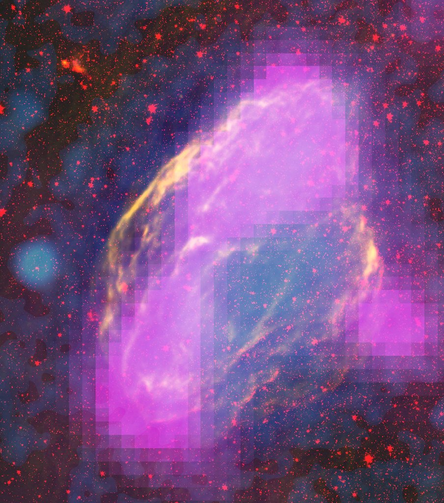 Multiwavelength composite of an oval supernova remnant, with magenta blocks of gamma-ray brightness laid over a yellow radio shell and red infrared stars.