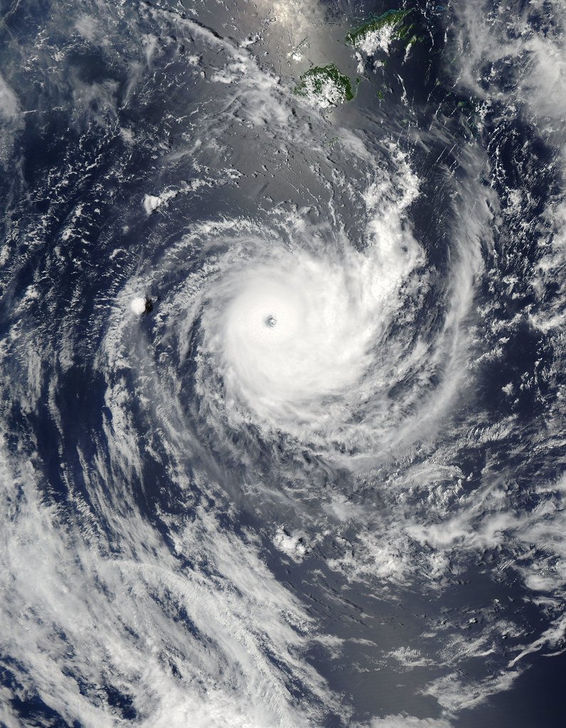 Satellite view of a tropical cyclone with a distinct eye over the ocean near the Fiji islands.