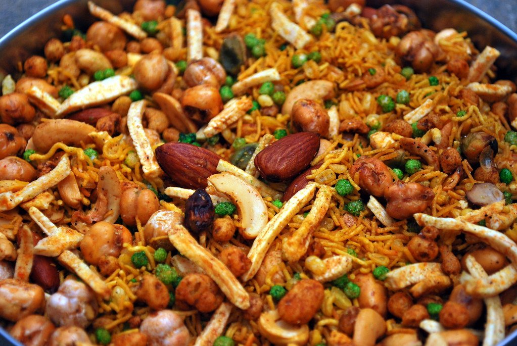 Close view of a fried snack mix of nuts, chickpeas, lentils and crisp noodles.