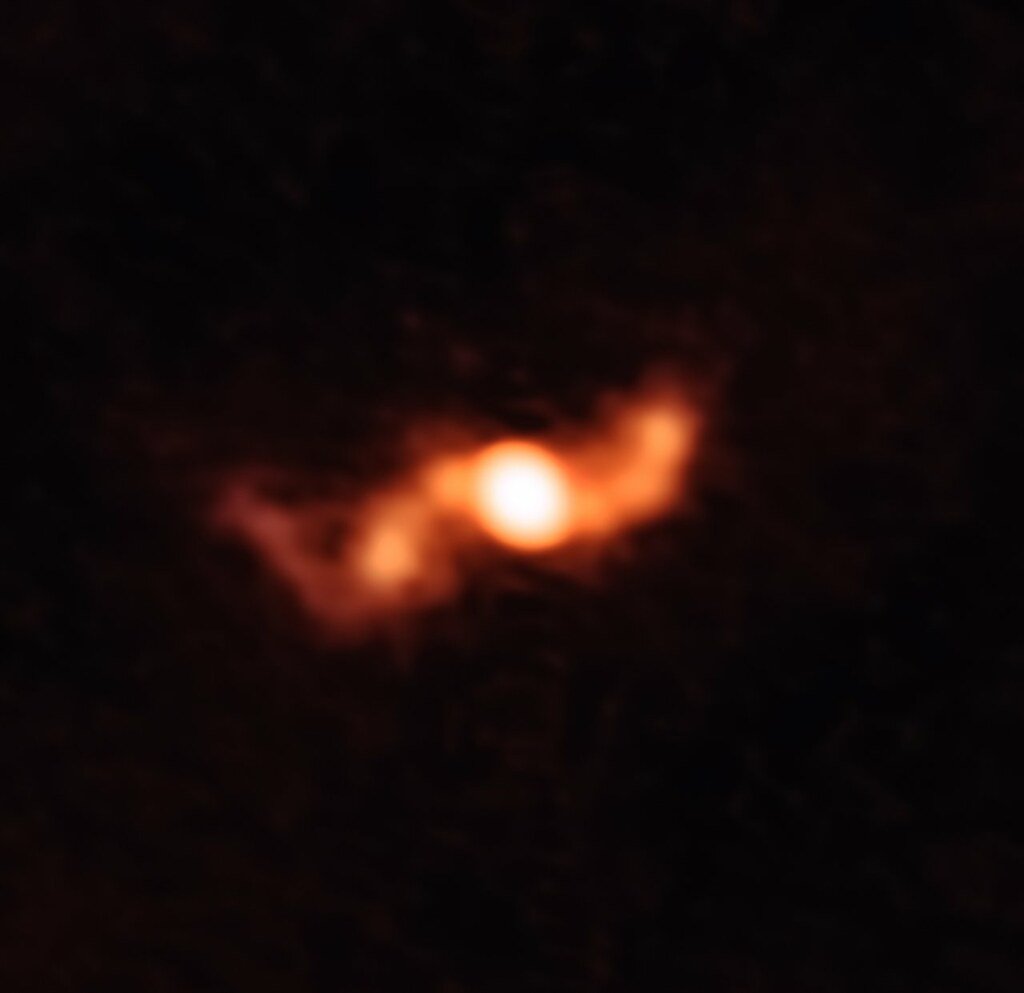 Radio image of the microquasar SS 433 showing a bright central source with fainter clumps strung out to either side along the jet axis.