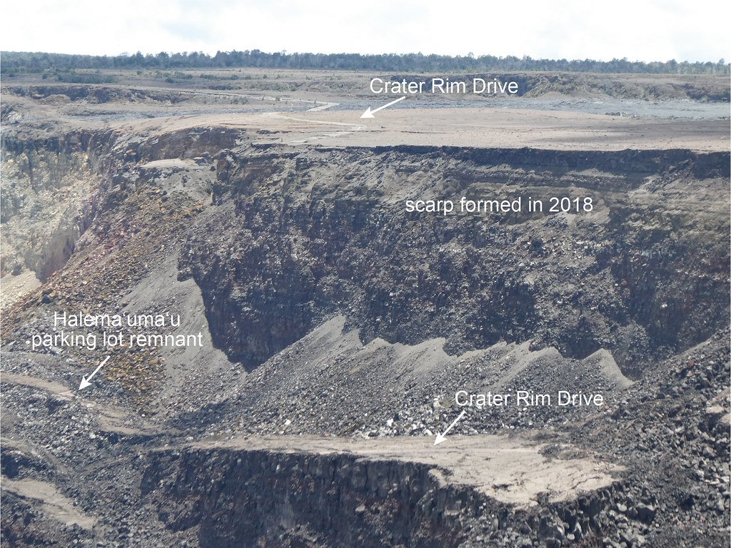 An annotated photograph of a collapsed crater wall, with labels pointing to the scarp formed in 2018, two sections of Crater Rim Drive and a parking lot remnant.
