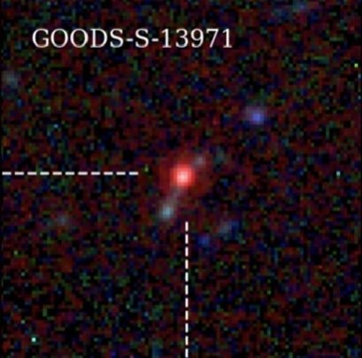 A small square telescope image showing a compact red point of light with faint galaxies nearby in a noisy dark field, crossed by two dashed white lines.