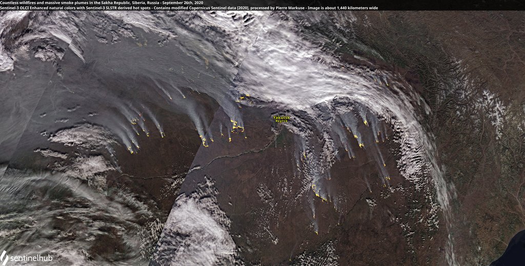 Sentinel-2 satellite view of dozens of small yellow hot spots in eastern Siberia, each trailing a pale plume of smoke to the east.